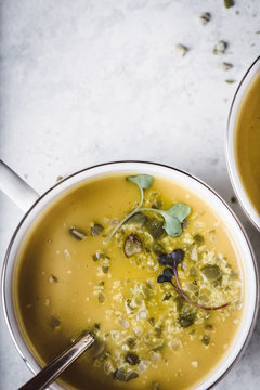 Curried Butternut Squash Soup with Crushed Pumpkin Seeds and Microgreens