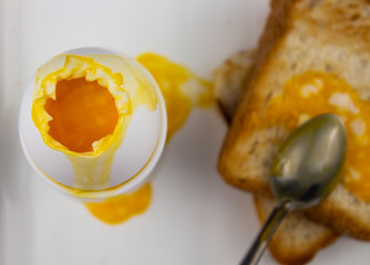Sandwich with Poached Egg - sliced and egg on toasted bread for healthy breakfast or snack, copy space.