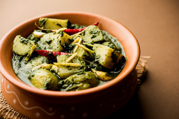 Aloo Palak sabzi or Spinach Potatoes curry served in a bowl. Popular Indian healthy recipe. Selective focus