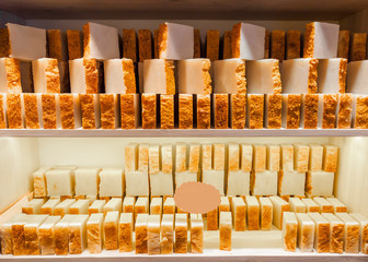 Bars of soap on a shop window. Turmeric soap with natural cedar oil and herbal ingredients....