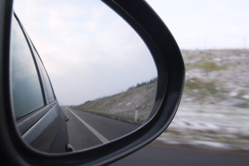 Objects in the mirror. Car back mirror  and road. Side rear mirror of car show straight road - view of a road side of the car, Drive Thru, Traveling Theme