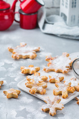 Fototapeta na wymiar Homemade christmas snowflake cookies on a cozy kitchen table