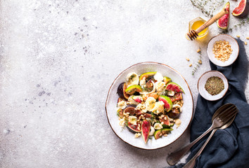 Salad with figs Mozzarella Thymean, Cedar Nut and honey.Healthy Food on the Stone Background. Nutrition Concept.Top View.Copy space for Text.
