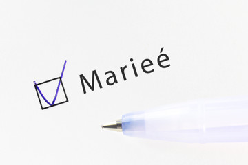 Married - checkbox with a cross on white paper with blue pen. Checklist concept