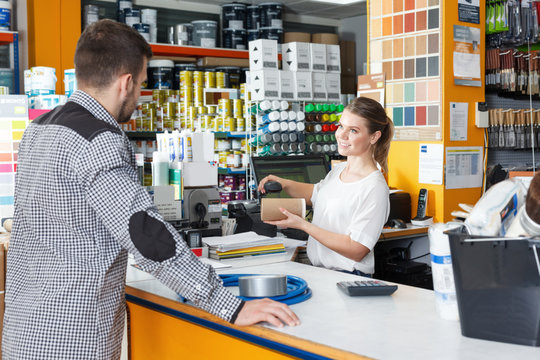 Female seller standing at the counter and consulting  male