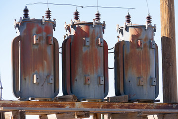 Old electrical transformers on a wooden structure