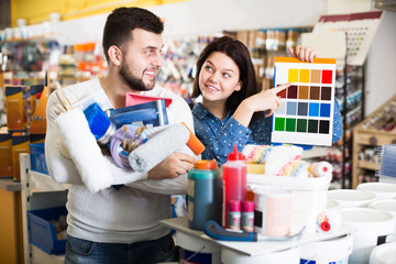 Couple in paint supplies store