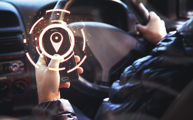 GPS concept. Man using a phone while driving a car.