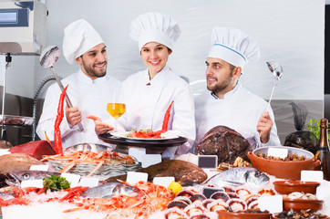 Chefs offering seafood in restaurant