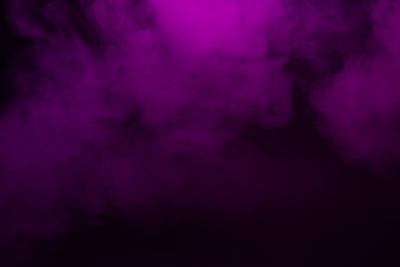 Obraz na płótnie Canvas Colorful smoke close-up on a black background