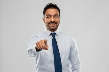 business, office worker and people concept - smiling indian businessman in shirt with tie over grey background