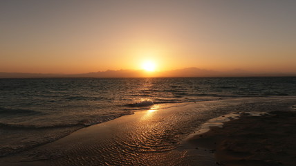 Reflection of the sunset on a beach at the coast of the Red Sea in Egypt