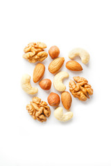 Isolated nuts pattern background. Walnut, cashew, almond and hazelnut on white background. View from above.