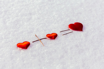 Two small red hearts and one big on the snow. Love. Background Valentines Day. Valentines day cards.
