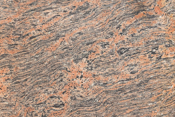 Pink orange black Indian flat granite texture background