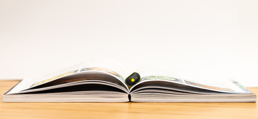 Book. Opened. Desk. Isolated. White. Marker