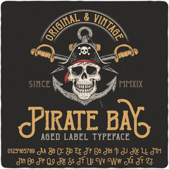 Vintage label typeface named Pirate Bay. Strong original logo font. Capital and small letters with numbers. Hand drawn illustration of pirate skull. - 245176003