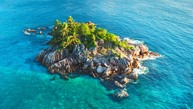 Tropical island with sea and palm taken from drone. Seychelles aerial photo. St Pierre Island