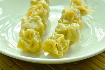 Chinese dumpling stabbing wooden stick on plate