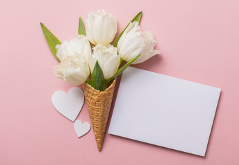 Flat-lay waffle cone with white flower blossom
