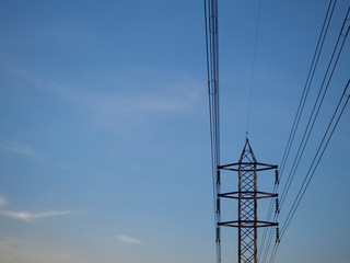 low angle high voltage electric pole with blue sky