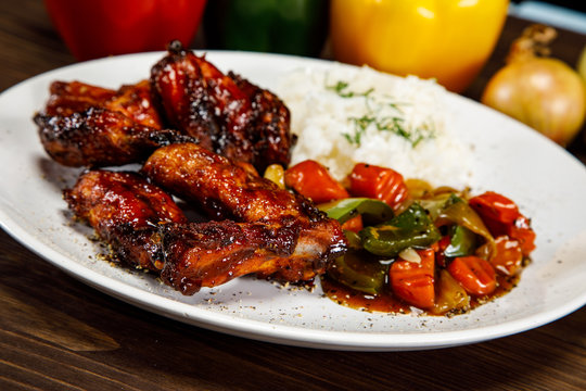 Roasted chicken wings white rice and vegetables