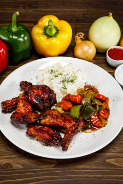 Roasted chicken wings white rice and vegetables