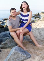 Fototapeta premium Happy loving couple sitting and hugging