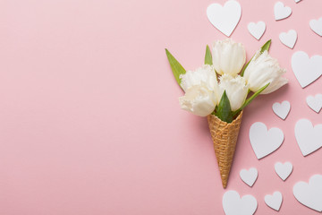 Flat-lay waffle cone with white flower blossom
