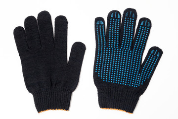 Closeup pair of black textile knitted gloves with professional blue rubber protective anti-slip coating isolated on white background. Concept builder and carpenter, welder, automechanic, cleaning