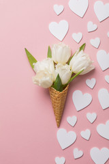 Flat-lay waffle cone with white flower blossom