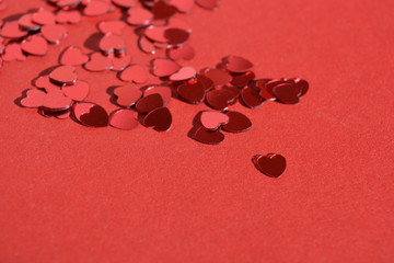 red hearts on red background with copy space