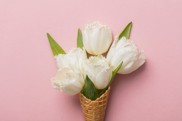 Flat-lay waffle cone with white flower blossom