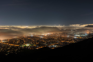 Aerial night view of fog over Los Angeles, Pasadena and Glendale in Southern California.