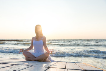 Woman meditating at the sea