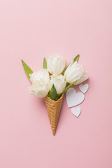 Flat-lay waffle cone with white flower blossom