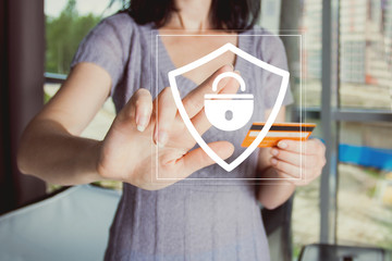 Businessman pressing button locked shield virus security service on credit card.