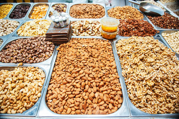 Nuts of various kinds in metal trays on the street market