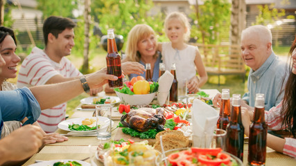 Big Family Garden Party Celebration, Gathered Together at the Table, Eating, Joking and Having Fun.