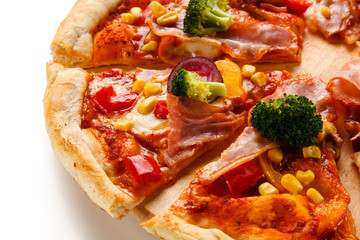 Pizza with bacon and vegetables on cutting board on white background