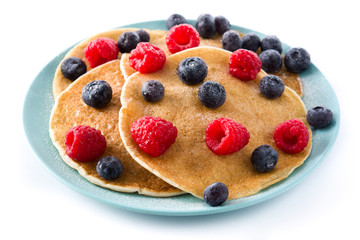 Pancakes with raspberries and blueberries isolated on white background. Close up

