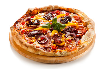 Pizza with ham, corn, mushrooms and dried tomatoes on white background