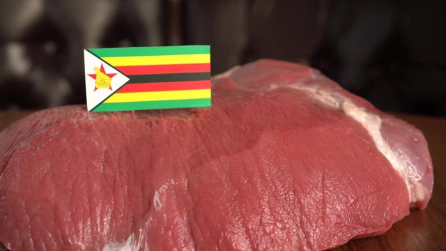 Raw meat and flag of Zimbabwe. Fresh and frozen meat trading, particularly in beef, veal, lamb