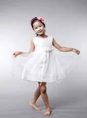 Naklejka premium Cute Asian Chinese little girl indoors against white background