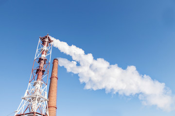 Obraz premium Smoke from the factory pipes. Ecological problem, mining enterprise with smoke stacks. Dirty smoke on the sky. Environmental issues. harmful emissions. Bad ecology. - Image