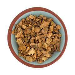 Gentian root in a small bowl on a white background