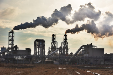 Fototapeta na wymiar Industrial plant with smoke emissions on the background of the sky.