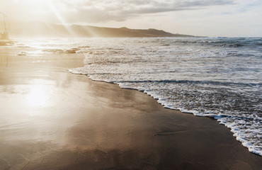 Sandy coast of the island, waves. Tourism, tranquility, vacation at sea, cruise.