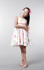 Cute Asian Chinese little girl indoors against white background