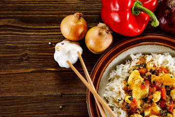 Grilled meat, white rice and vegetables on wooden table